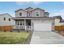 Charming two-story home featuring a stone facade and a spacious two car garage at 100 Stinson Pl, Castle Pines, CO 80108