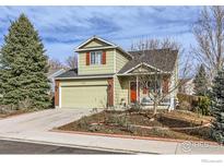 Charming two-story home with a well-manicured lawn and attached two-car garage at 1026 Red Oak Dr, Longmont, CO 80504
