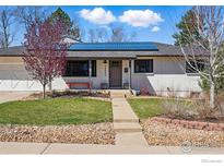 Charming home featuring solar panels, well-maintained landscaping, and a welcoming entrance at 13905 W 21St Ave, Golden, CO 80401