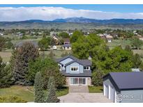 Charming two-story home with stone accents and lush landscaping in a peaceful neighborhood at 2610 W County Road 4, Berthoud, CO 80513