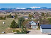 Charming two-story home with mountain views, mature trees and lush landscaping at 2610 W County Road 4, Berthoud, CO 80513