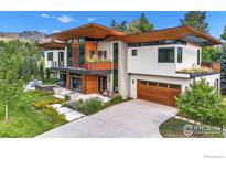 Contemporary home boasting a sleek design, wood accents, and lush landscaping at 3633 Broadway St, Boulder, CO 80304