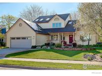Charming two-story home with red door, beautiful landscaping and a well-maintained lawn at 4462 Wellington Rd, Boulder, CO 80301