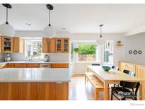 Open kitchen with wood cabinets, subway tile backsplash, white countertops and pendant lighting at 5292 Lichen Pl, Boulder, CO 80301