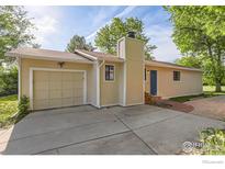 Charming single-story home with a well-maintained front yard and a convenient attached garage at 6396 Twin Lakes Rd, Boulder, CO 80301