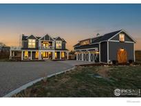 Beautiful exterior elevation featuring a charming two-story home with a large garage at 6685 Baseline Rd, Boulder, CO 80303