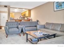 Inviting living room featuring modern gray furniture and an open layout to the kitchen at 805 29Th St # 204, Boulder, CO 80303