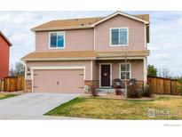 Charming two-story home with a two-car garage and well-maintained front lawn at 1022 Wagon Bend Rd, Berthoud, CO 80513