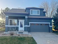 Charming two-story home with a well-manicured lawn and a two-car garage at 13874 Adams Cir, Thornton, CO 80602