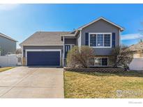 Charming two-story home with a well-maintained lawn, attached garage and beautifully painted exterior at 16282 Ginger Ave, Mead, CO 80542