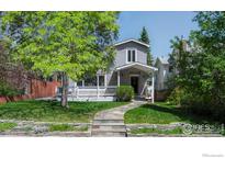 Charming home featuring a cozy front porch, stone pathway, and lush lawn at 1835 Columbine Ave, Boulder, CO 80302
