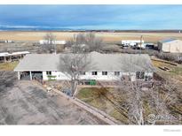 Sprawling ranch-style home featuring an expansive yard and inviting outdoor living spaces, perfect for serene countryside living at 20995 County Road 28, Hudson, CO 80642