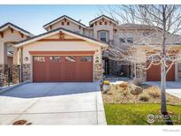 Charming home showcasing a two-car garage, well-kept lawn, and beautiful landscaping at 2966 Casalon Cir, Superior, CO 80027