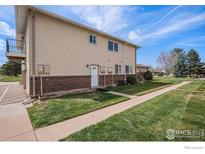 Inviting two-story townhome with well-maintained lawn and exterior, offering a charming and welcoming appeal at 3354 S Flower St # 68, Lakewood, CO 80227