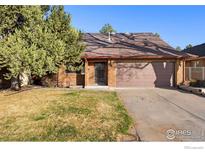 Charming single-Gathering home featuring brick facade, established trees, and attached two-car garage at 337 Eagle Ct, Longmont, CO 80504