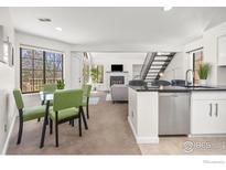 Bright living room with dining area, modern kitchen, fireplace, and staircase to upper level at 5904 Gunbarrel Ave # B, Boulder, CO 80301