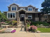 Charming two-story home with landscaped front yard and inviting entrance; stone and siding exterior at 789 Zamia Ave, Boulder, CO 80304