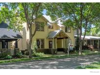 Charming two-story home with a welcoming front porch and lush landscaping at 832 Neon Forest Cir, Longmont, CO 80504