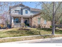 Charming two-story home features a stone facade and a well-maintained front yard at 16518 Red Rock Ln, Broomfield, CO 80023