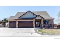 Inviting single-Gathering home boasts a three-car garage, manicured lawn, and charming front porch at 2101 Breckenridge Dr, Berthoud, CO 80513