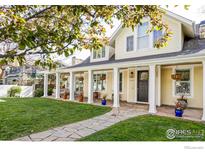Charming two-story home featuring a welcoming front porch, stone pathway, and a lush green lawn at 3132 5Th St, Boulder, CO 80304