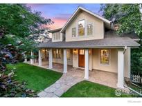 Charming two-story home with a welcoming front porch and well-maintained lawn in a lovely setting at 3132 5Th St, Boulder, CO 80304