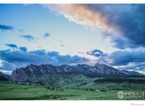 Scenic mountain view with green valley below and beautiful clouds in the sky at sunset at 3786 Eldorado Springs Dr, Boulder, CO 80303