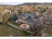 Aerial view showcasing a spacious backyard with a deck, hot tub, mature trees, and mountain views at 4156 15Th St, Boulder, CO 80304