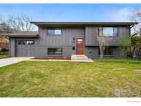 Charming two-story home with a modern orange front door and well-maintained lawn at 4380 Butler Cir, Boulder, CO 80305