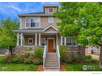 Charming two-story home featuring a covered front porch, stone accents, and a well-manicured lawn at 4921 Fountain St, Boulder, CO 80304