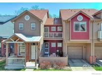 Inviting townhome with a cozy porch, two stories, and appealing architectural details on a sunny day at 835 Kane Dr # 25, Longmont, CO 80501