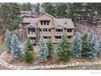 Lovely home exterior with stone accents, mature evergreens, and a neutral color palette at 1782 Tulip Tree Pl, Castle Rock, CO 80108