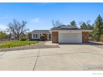 Charming brick home featuring a two-car garage and a well-maintained front yard at 2819 Lake Park Way, Longmont, CO 80503
