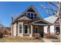 Charming two-story home with unique architectural details and a cozy front porch at 4337 Umatilla St, Denver, CO 80211