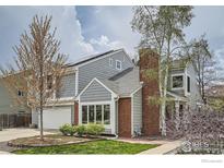 Charming two-story home featuring a gray exterior with brick accents and attached garage at 5275 Holmes Pl, Boulder, CO 80303