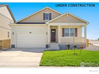 Inviting two-story home with a charming front porch, fresh lawn, and a two car garage at 817 Ledge St, Lochbuie, CO 80603