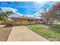 Charming single-story home with a brick exterior, and a long driveway at 9840 W 41St Ave, Wheat Ridge, CO 80033