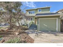 Charming two-story home with green siding and a well-maintained front yard and attached one car garage at 1149 Quince Ave, Boulder, CO 80304