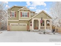 Charming two-story home featuring a welcoming front porch and attached two-car garage at 22898 E Saratoga Pl, Aurora, CO 80015
