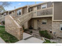 Charming townhouse showcases a brick facade and inviting outdoor staircases leading to upper-level units at 2660 E Otero Pl # 7, Centennial, CO 80122