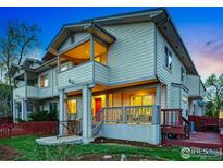Inviting two-story townhome with charming front porch and well-maintained red fence at 2700 Valmont Rd # 5, Boulder, CO 80304