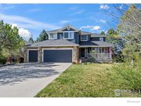 Beautiful two-story home with stone accents, attached three-car garage, and charming front porch at 5397 Wild Dunes Ct, Boulder, CO 80301