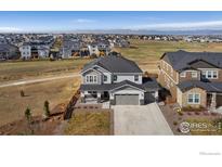 Beautiful two-story home with well-kept lawn, three-car garage, and mountain view at 806 Flora View Dr, Erie, CO 80516