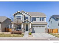 Charming two-story home featuring a covered front porch and a two-car garage in a well-kept neighborhood at 878 Wagon Bend Rd, Berthoud, CO 80513