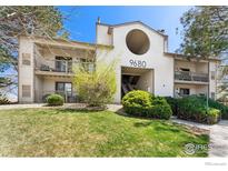 Inviting condo building with balconies and well-maintained landscaping on a sunny day at 9680 Brentwood Way # 203, Broomfield, CO 80021
