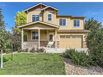 Charming two-story home featuring a covered front porch, two-car garage, and well-manicured lawn at 1512 Lasalle Way, Longmont, CO 80504