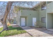 Inviting exterior view of condo featuring a well-manicured lawn and tidy landscaping at 1805 Chalcis Dr # E, Lafayette, CO 80026