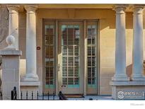 Inviting front door framed by stone pillars, providing an elegant entrance to this home at 1950 N Logan St # 102, Denver, CO 80203
