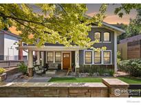 Charming two-story home with a covered front porch and manicured lawn, perfect for relaxing or entertaining at 3080 7Th St, Boulder, CO 80304