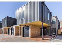Modern townhome featuring a metal and brick exterior with a private garage and sleek, contemporary design at 3309 Broadway Ave, Boulder, CO 80304